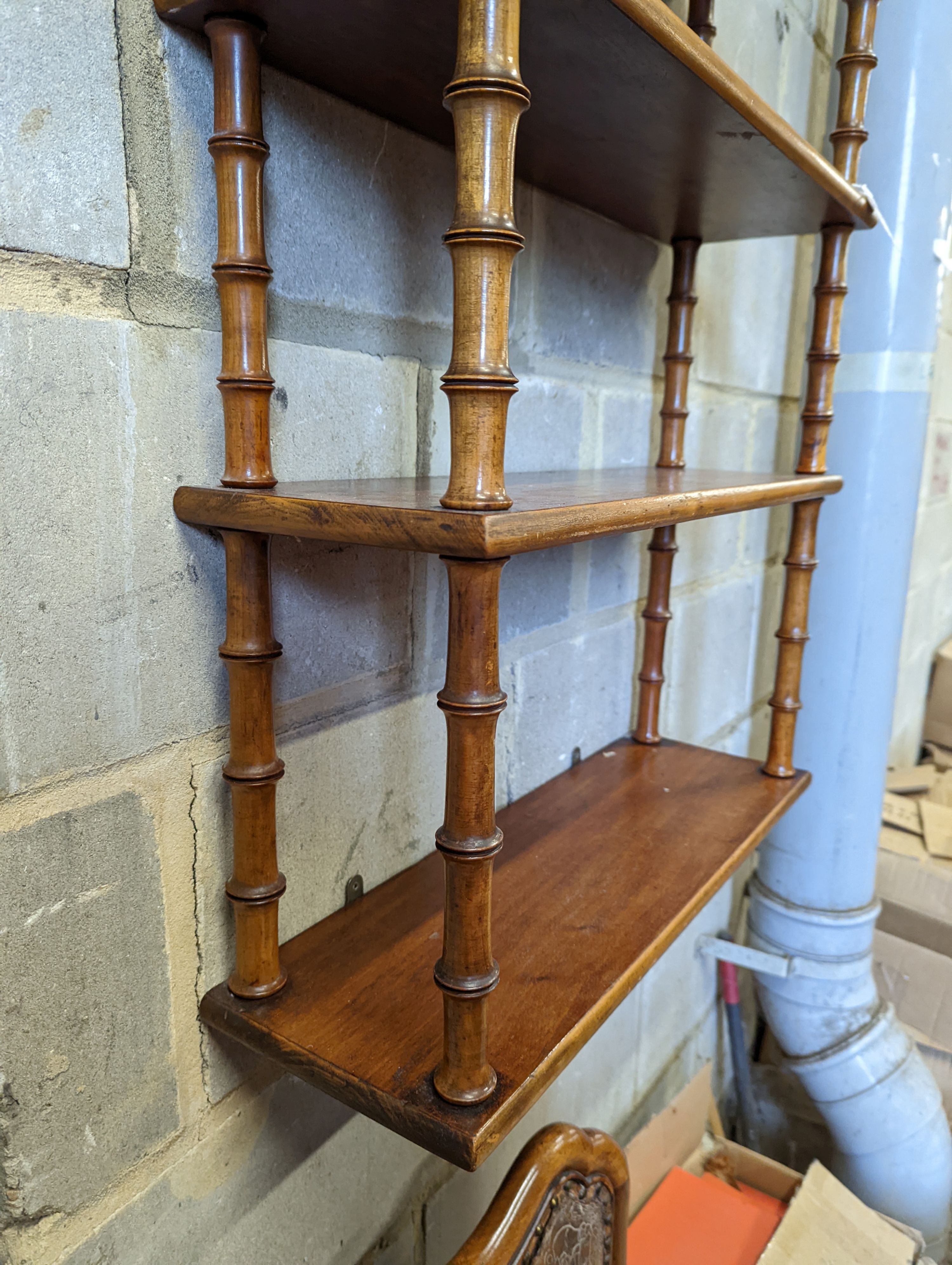 A Regency style mahogany four tier wall bracket, width 60cm, depth 19cm, height 80cm